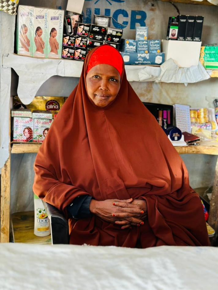 A photograph captures Amal Mahad inside her small shop located in the Shader refugee camp in Ethiopia. © Dereje Agize, Mercy Corps