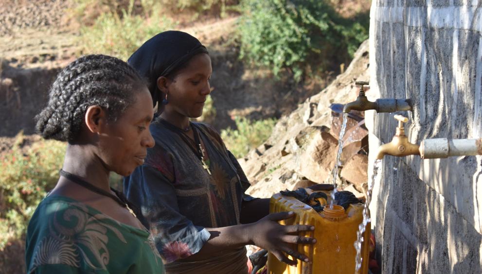 Denkayehu Kassahun and Enbere Fentaw at the Gurumba Spring water-point in the highlands of Sekota, Amahara region, Ethiopia - @Danish Church Aid