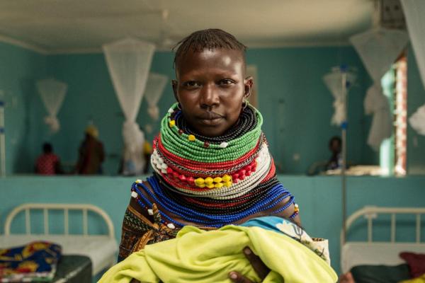 A Turkana woman poses for a photo with her new born at the Kalobeyei maternity. The maternity is accessed by refugees and Kenyans alike.