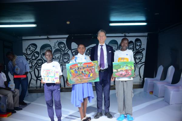 The triumphant trio of competition winners, pictured alongside Jan Sadek, the EU Ambassador. 